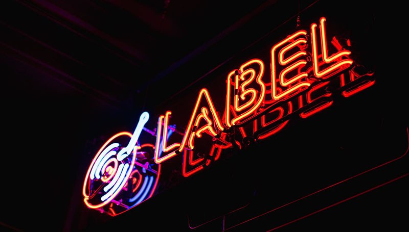 Photo of a Neon Record Label Sign | What DJs & Producers Need To Know About EDM Record Labels